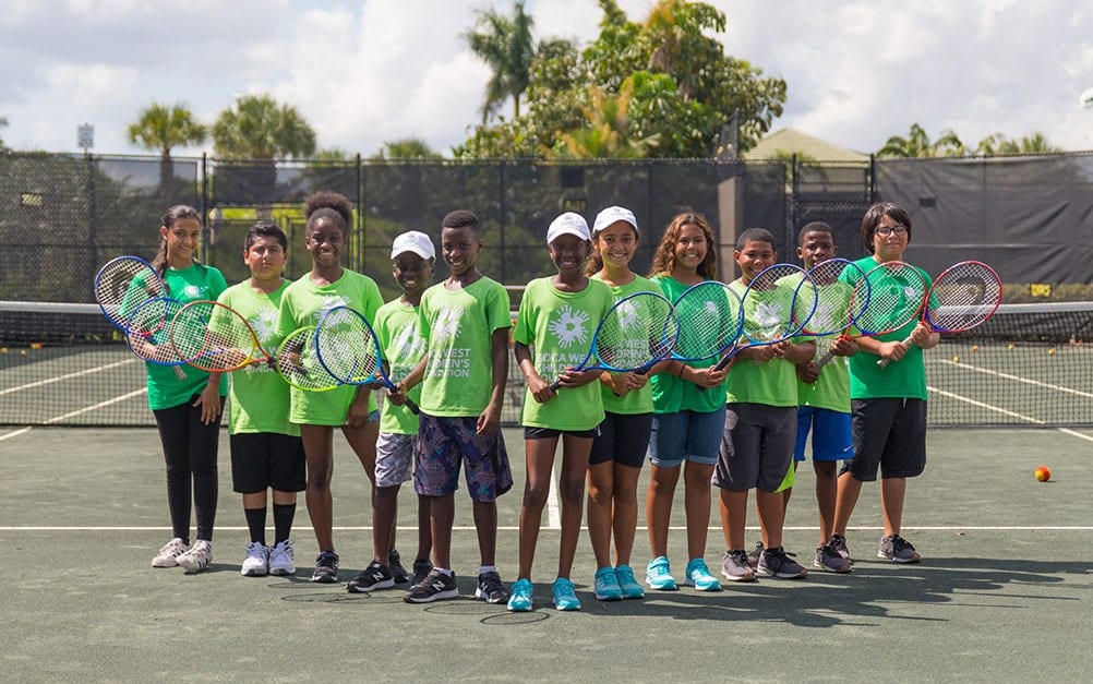 Group of children on a tennis court at Boca West