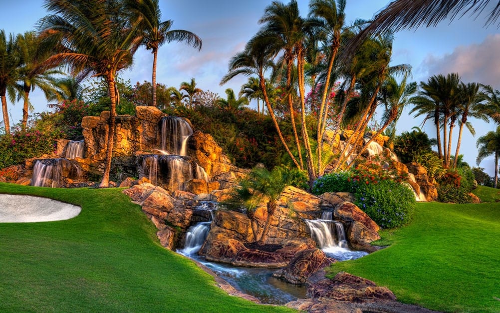 Magnificent Waterfall and palm trees on golf course at Boca West