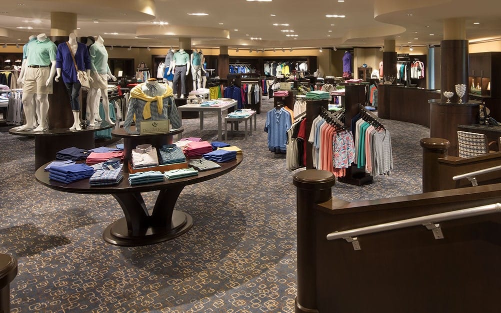 Boca West Pro Shop with golf apparel displayed on tables and racks