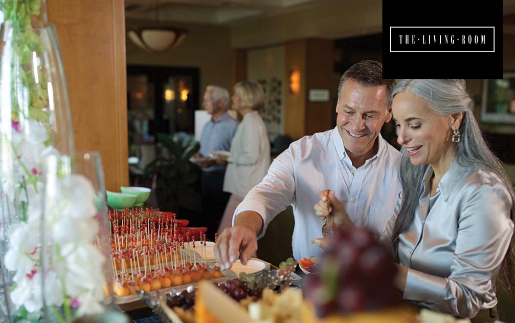 Couple serving themselves at buffet at Boca West's The Living Room