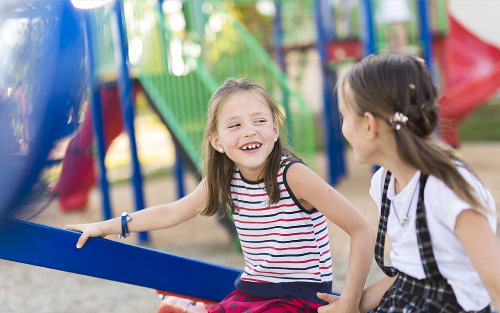 Two girls on playground at Boca West