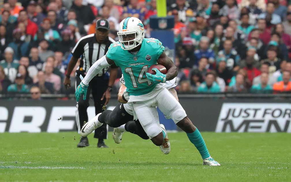 Miami Dolphin player carrying the ball