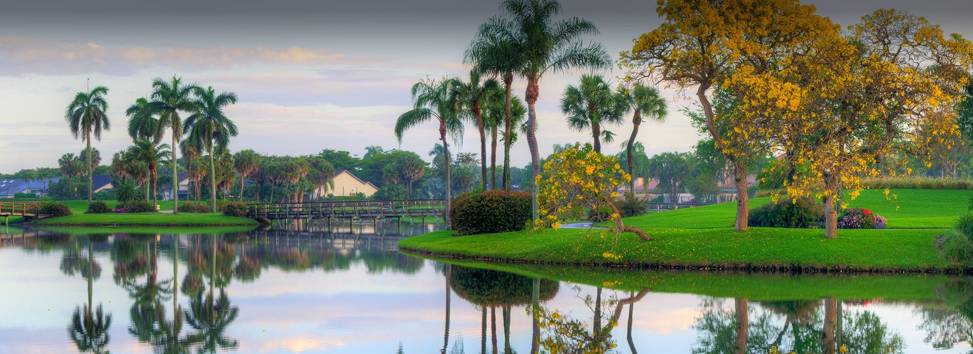 Large lake with palm trees surrounding it at Boca West
