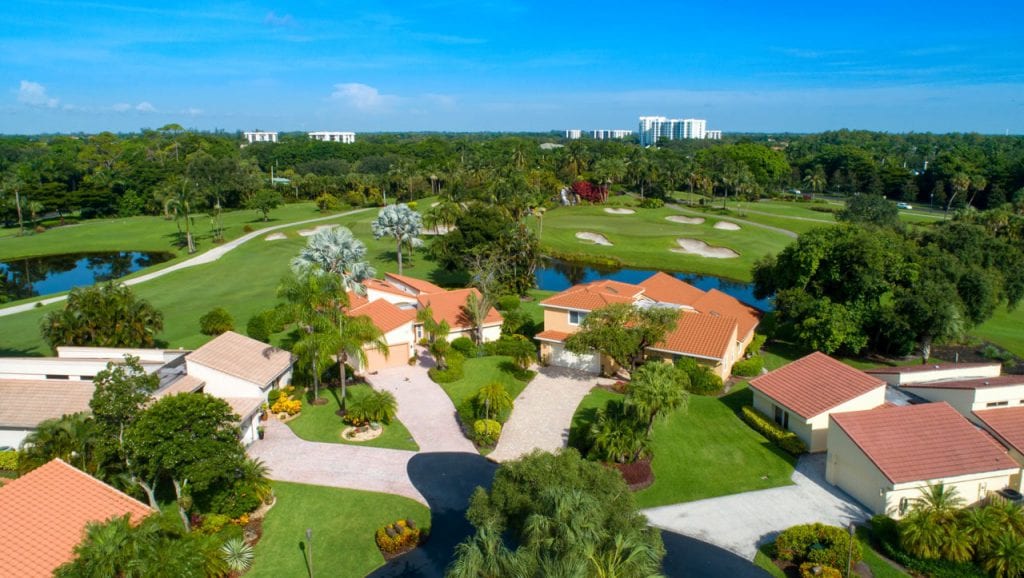 Cul de sac at Boca West with backyards of homes along golf course
