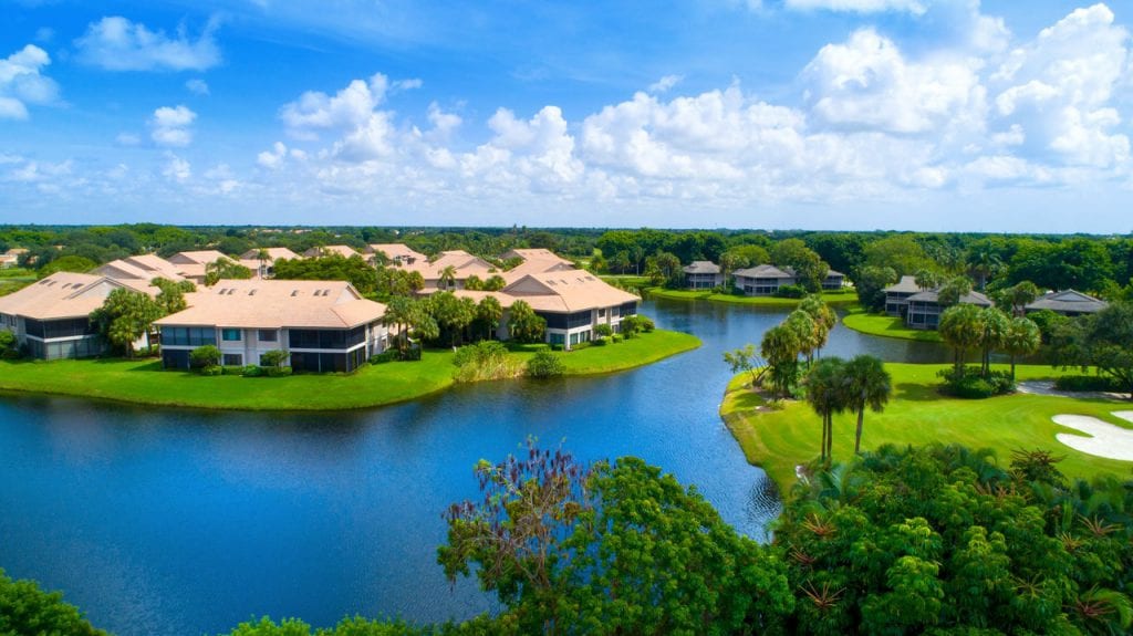 Boca West townhomes along water feature of golf course
