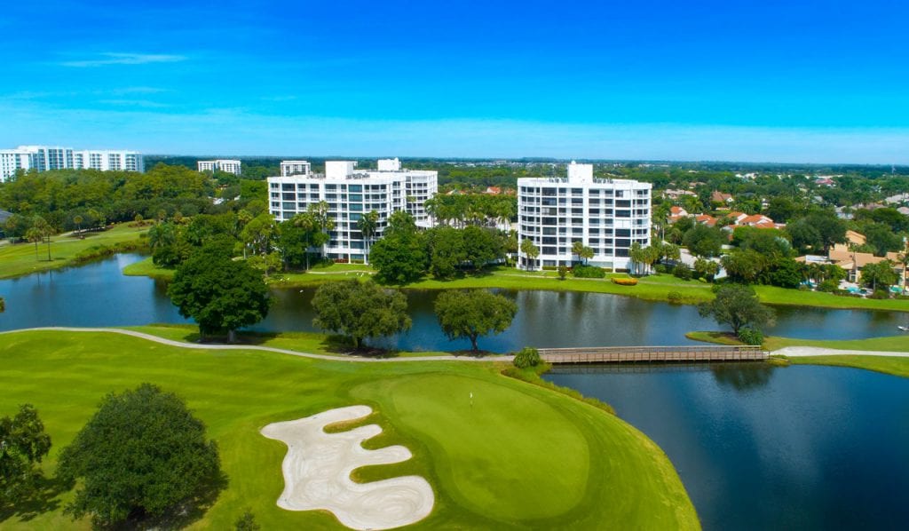 Boca West condominium buildings along water feature of golf course
