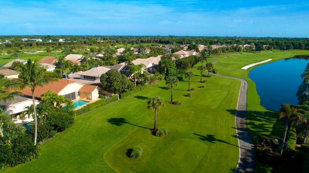 Tee boxes at Boca West golf course with houses along the fairway