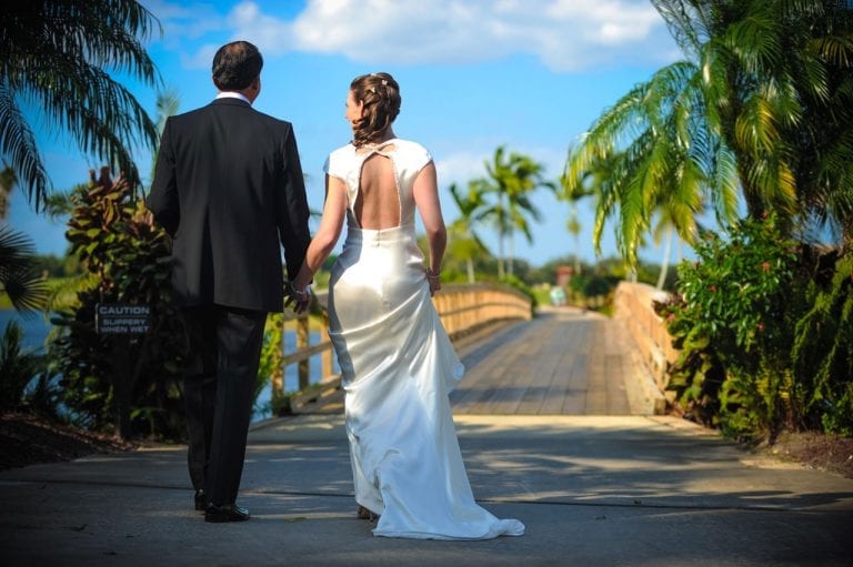 Bride &amp; Groom walking over bridge at Boca West