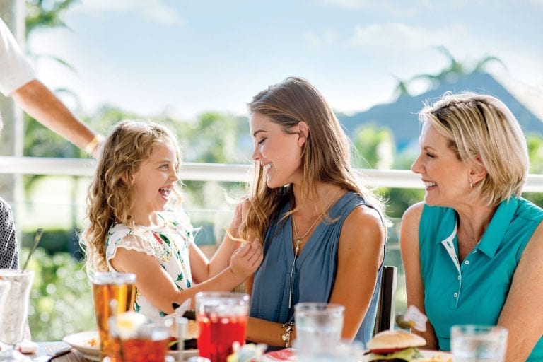 Three generations of women enjoying a meal at Boca West