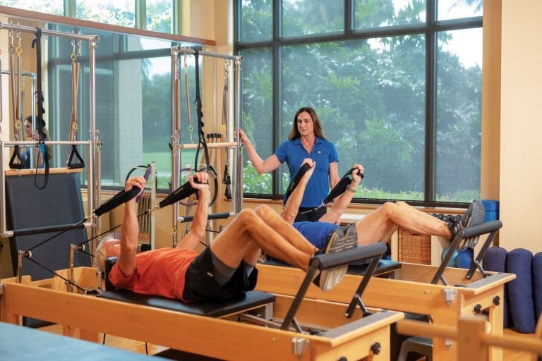 Trainer at Boca West assisting members during physical therapy