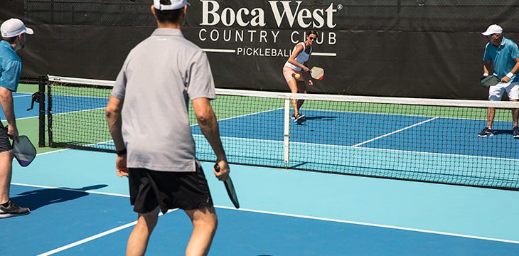 residents playing pickleball on boca west courts