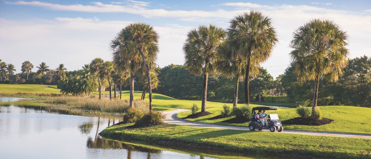 view of the Boca West golf course with a golf cart