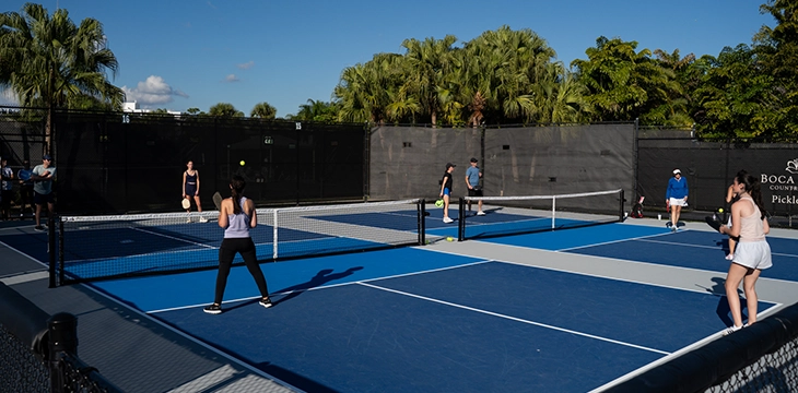 Players engaged in pickleball on outdoor courts