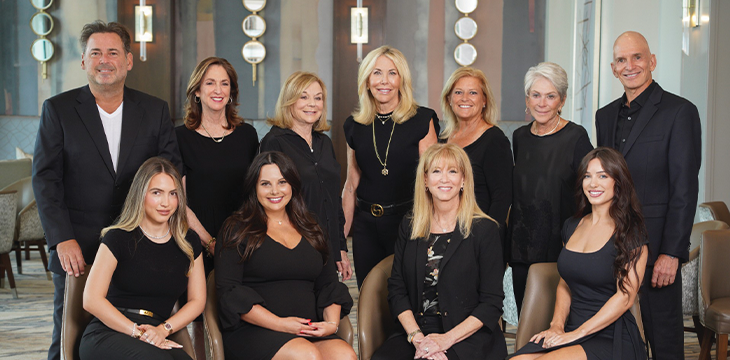 Group of people walking on paved path during community event.