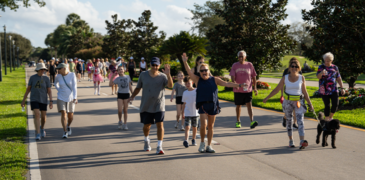 Group of professionally dressed adults posing indoors for portrait.