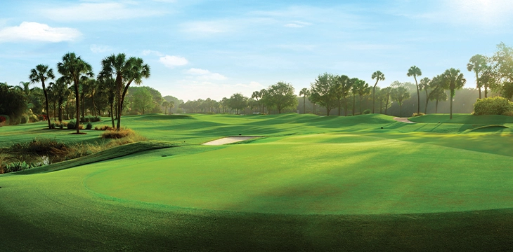 Panoramic aerial of golf course with lakes and bridges