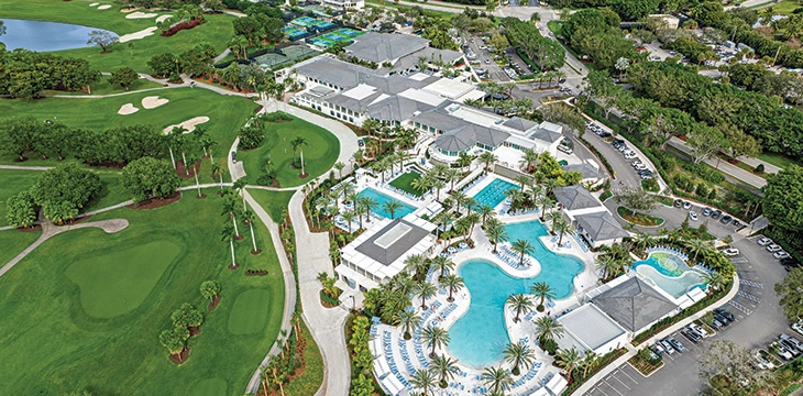 Aerial view of Boca West Country Club with pools, clubhouse and golf course.