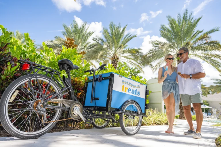 Couple enjoying popsicles from the Boardwalk Treats cart at Boca West.