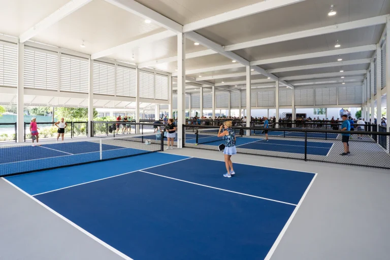 Row of covered pickleball courts at the Boca West Pickleball Club.