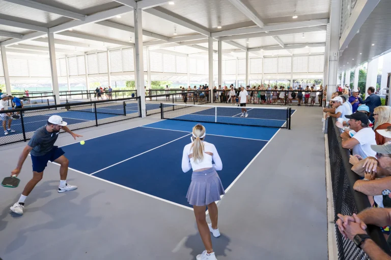 Close-up of a doubles pickleball match with spectators at Boca West.