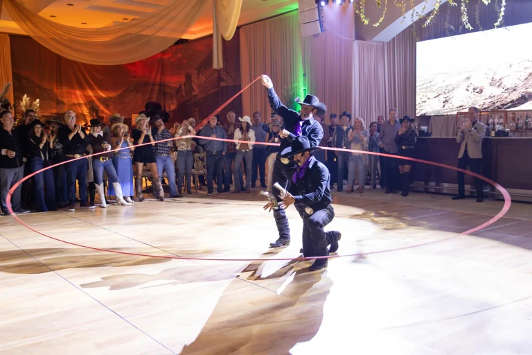 Rope trick performers on a dance floor at a Boca West western themed event.